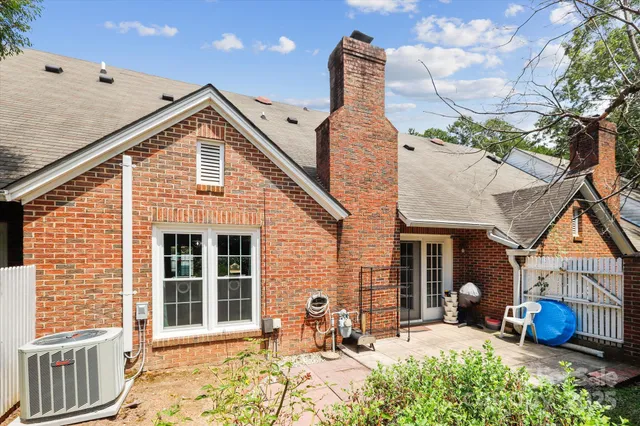 a front view of a house with outdoor seating and a potted plant