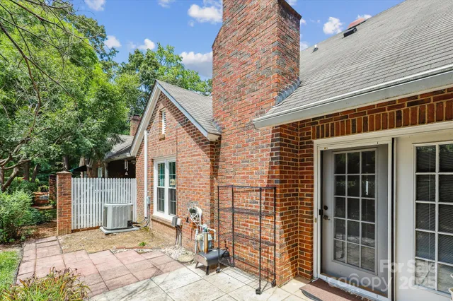 a view of a house with a door and wooden fence