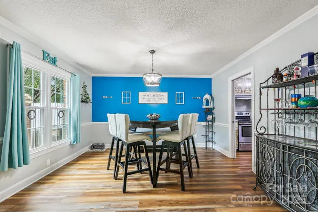 a view of a dining room with furniture window and wooden floor