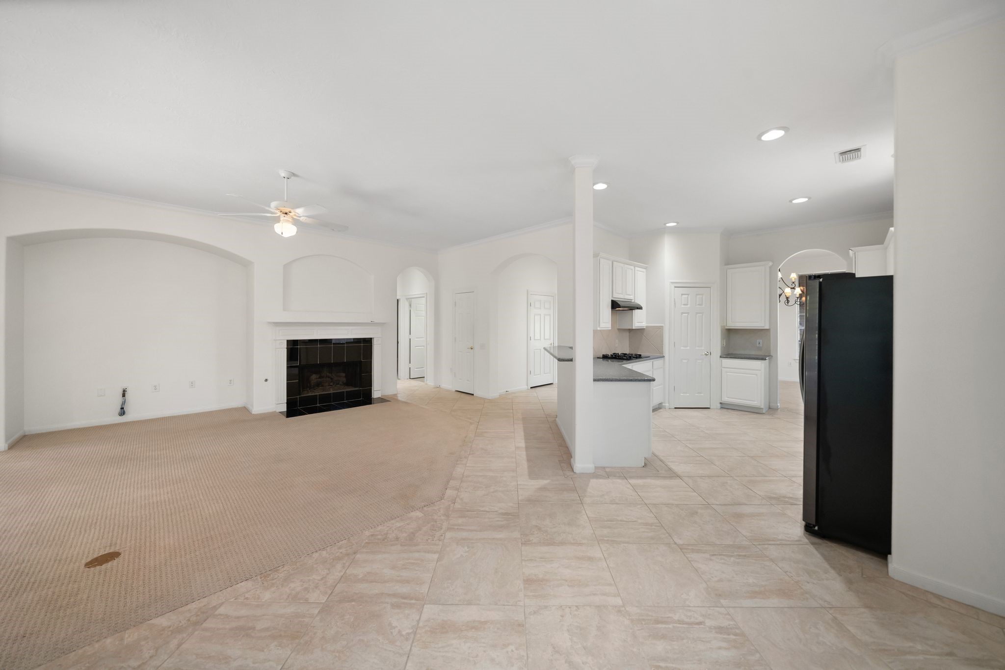 7 Sovereign Way Conroe, TX 77384 - Photo 6 of 31 a view of a kitchen with refrigerator and a fireplace
