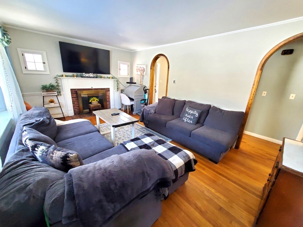 5 Elm Street Plympton, MA 02367 - Photo 4 of 19 a living room with furniture a flat screen tv and a fireplace