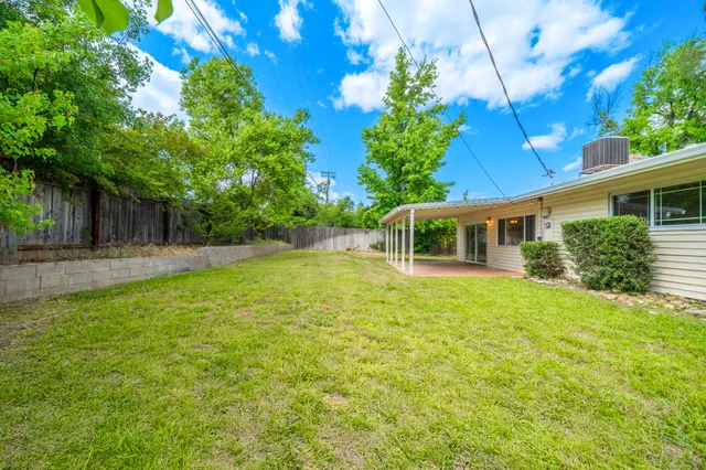 a view of a house with a backyard