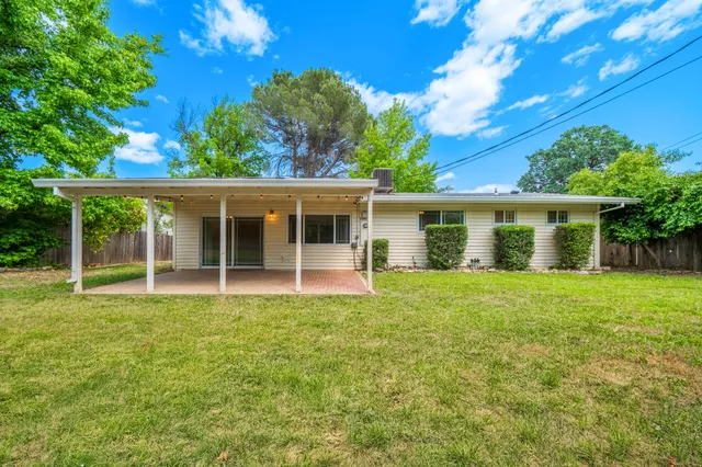 a view of a house with a backyard