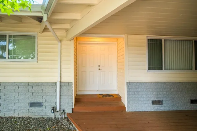 a front view of a house with white door