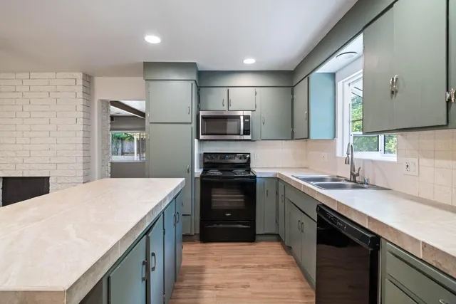 a kitchen with a sink stove and refrigerator