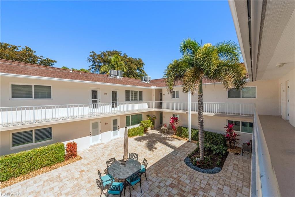 582 Broad Avenue South, Unit 582 Naples, FL 34102 - Photo 24 of 36 a front view of house with yard outdoor seating and barbeque oven