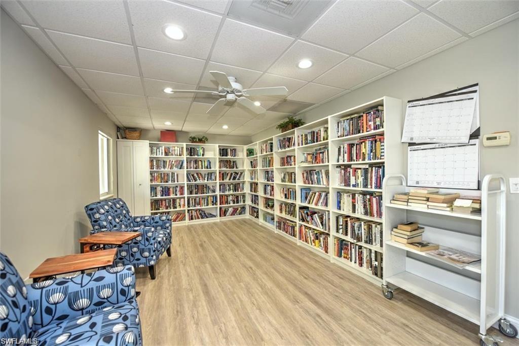 582 Broad Avenue South, Unit 582 Naples, FL 34102 - Photo 34 of 36 a bedroom with furniture and a book shelf