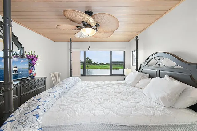 a view of kitchen island with granite countertop a sink and living room