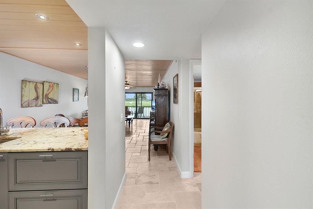 40 Northeast Plantation Road, Unit 109 Stuart, FL 34996 - Photo 15 of 41 a en suite bathroom with a granite countertop sink and a mirror