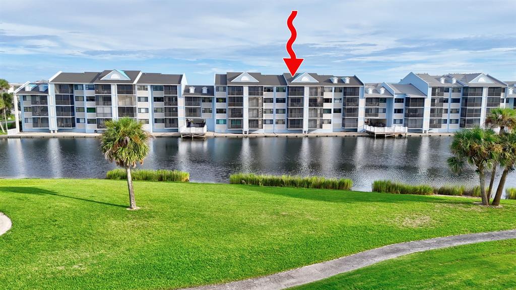 40 Northeast Plantation Road, Unit 109 Stuart, FL 34996 - Photo 38 of 41 a view of yard with swimming pool and yard