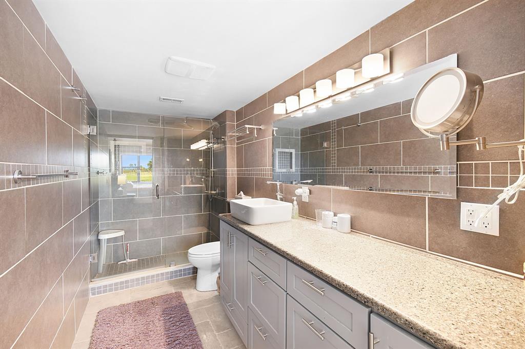 40 Northeast Plantation Road, Unit 109 Stuart, FL 34996 - Photo 4 of 41 a bathroom with a sink a toilet and shower