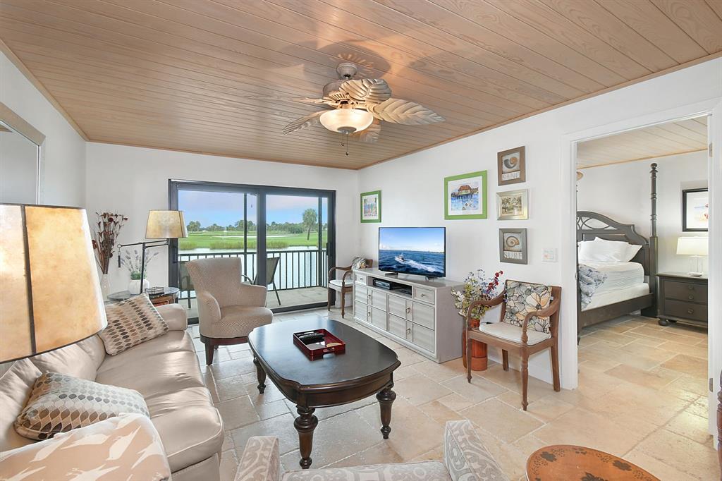 40 Northeast Plantation Road, Unit 109 Stuart, FL 34996 - Photo 7 of 41 a living room with furniture and a large window