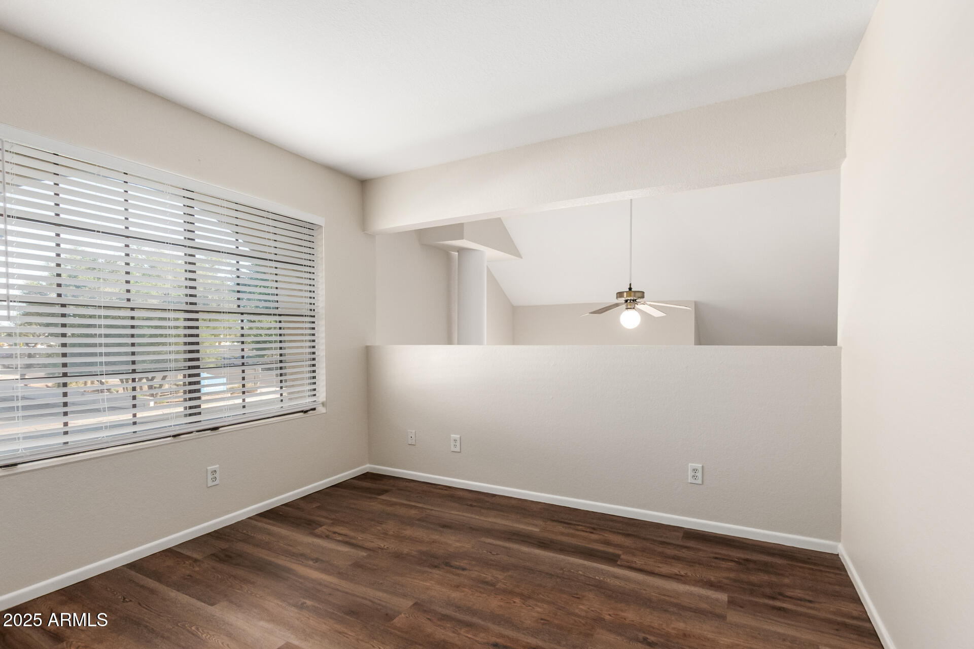 1126 West Elliot Road, Unit 1010 Chandler, AZ 85224 - Photo 13 of 32 a view of an empty room with wooden floor and a window