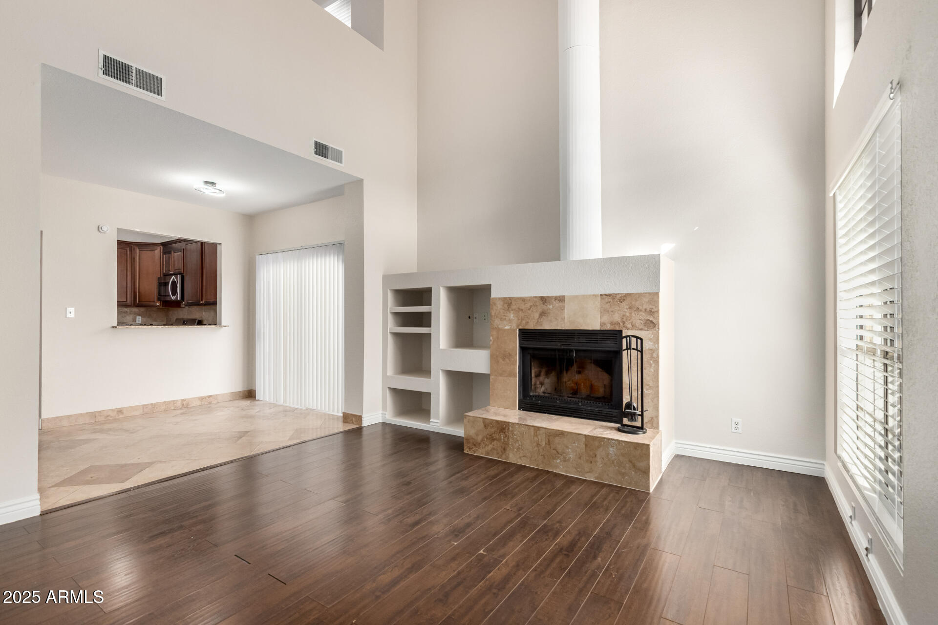 1126 West Elliot Road, Unit 1010 Chandler, AZ 85224 - Photo 4 of 32 a view of a livingroom with wooden floor and a fireplace