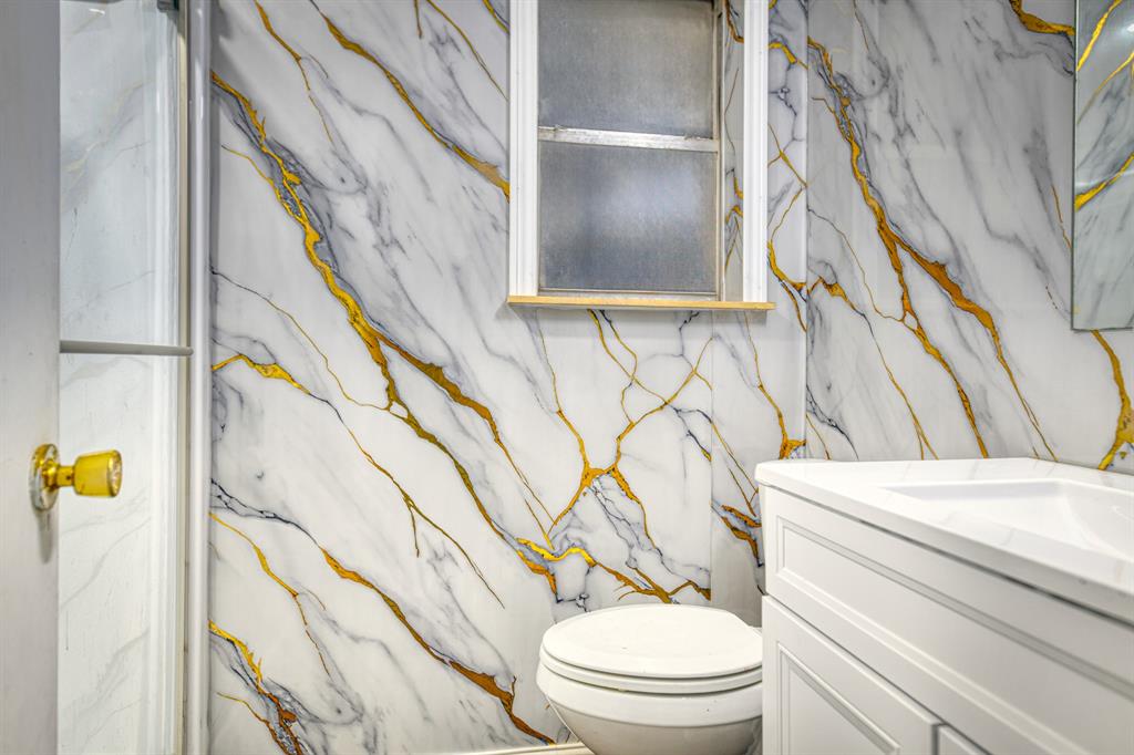 1304 Crestview Drive Kaufman, TX 75142 - Photo 12 of 26 a bathroom with a toilet a sink and a window