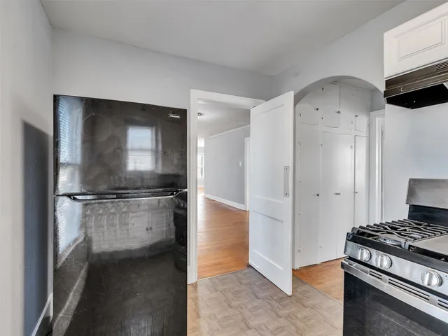 a kitchen with white cabinets and a stove top oven