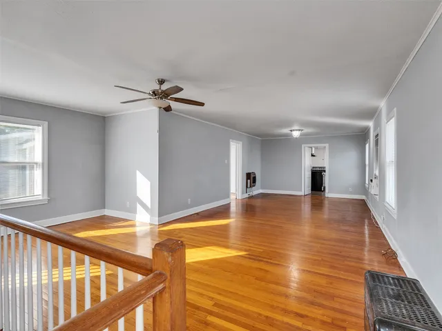 a view of a livingroom with a ceiling fan and window