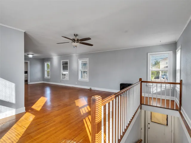 a view of livingroom with hardwood floor and a ceiling fan