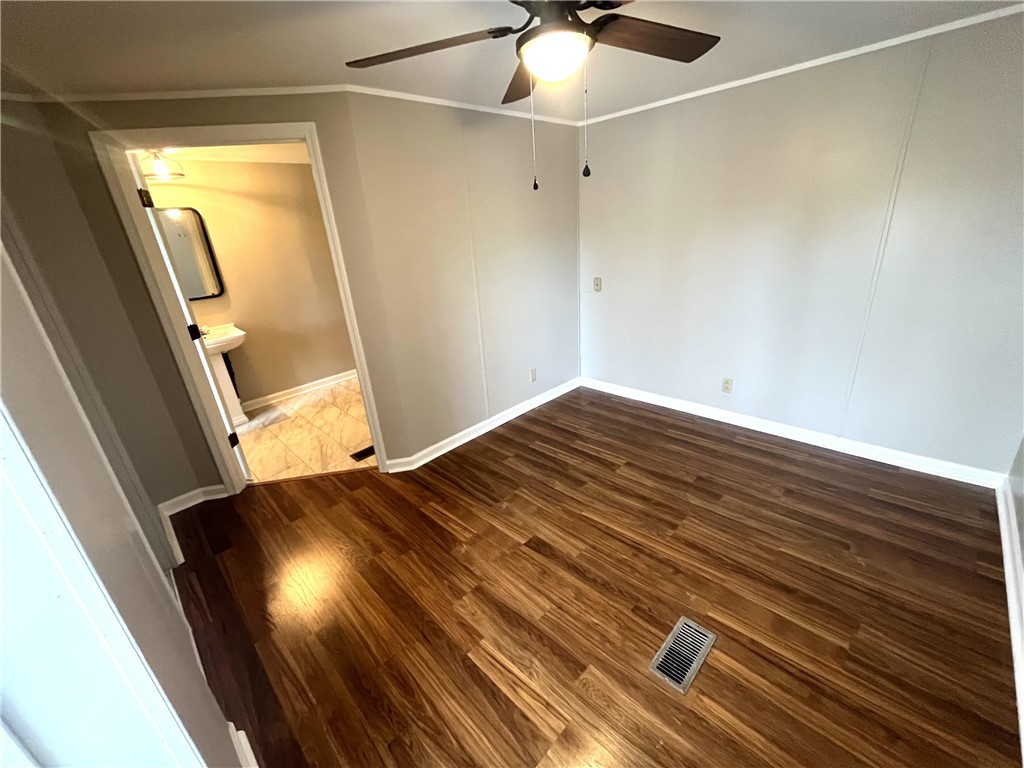 212 Whitewater Lake Road Tamassee, SC 29686 - Photo 5 of 9 Rich hardwood floors complement a neutral palette in this versatile room.