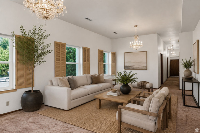 299 West Center Street, Unit 2 Logan, UT 84321 - Photo 6 of 46 Spacious living area featuring dual crystal chandeliers, multiple windows with natural wood shutters, a neutral color palette, and high ceilings