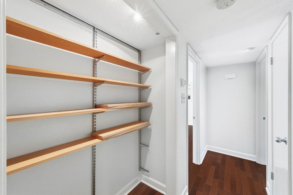 6210 Shadow Valley Drive, Unit B Austin, TX 78731 - Photo 16 of 28 Hall with dark wood-style flooring and baseboards