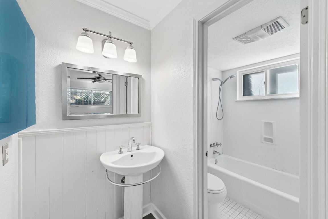 6210 Shadow Valley Drive, Unit B Austin, TX 78731 - Photo 19 of 28 Full bath with wainscoting, shower combination, natural light, ornamental molding, and a textured wall