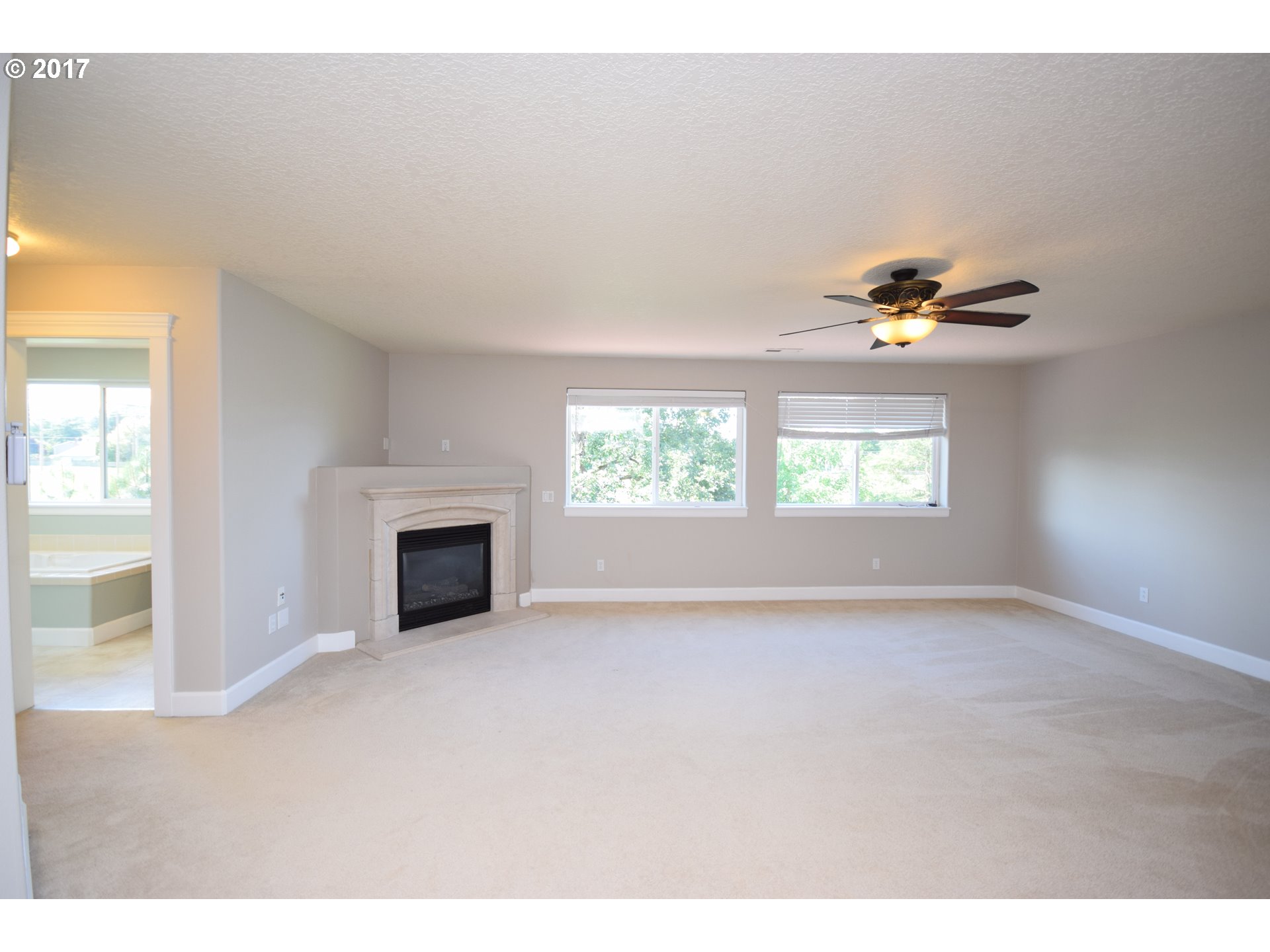 5229 Northwest Shoreline Way Portland, OR 97229 - Photo 22 of 29 an empty room with windows and fireplace