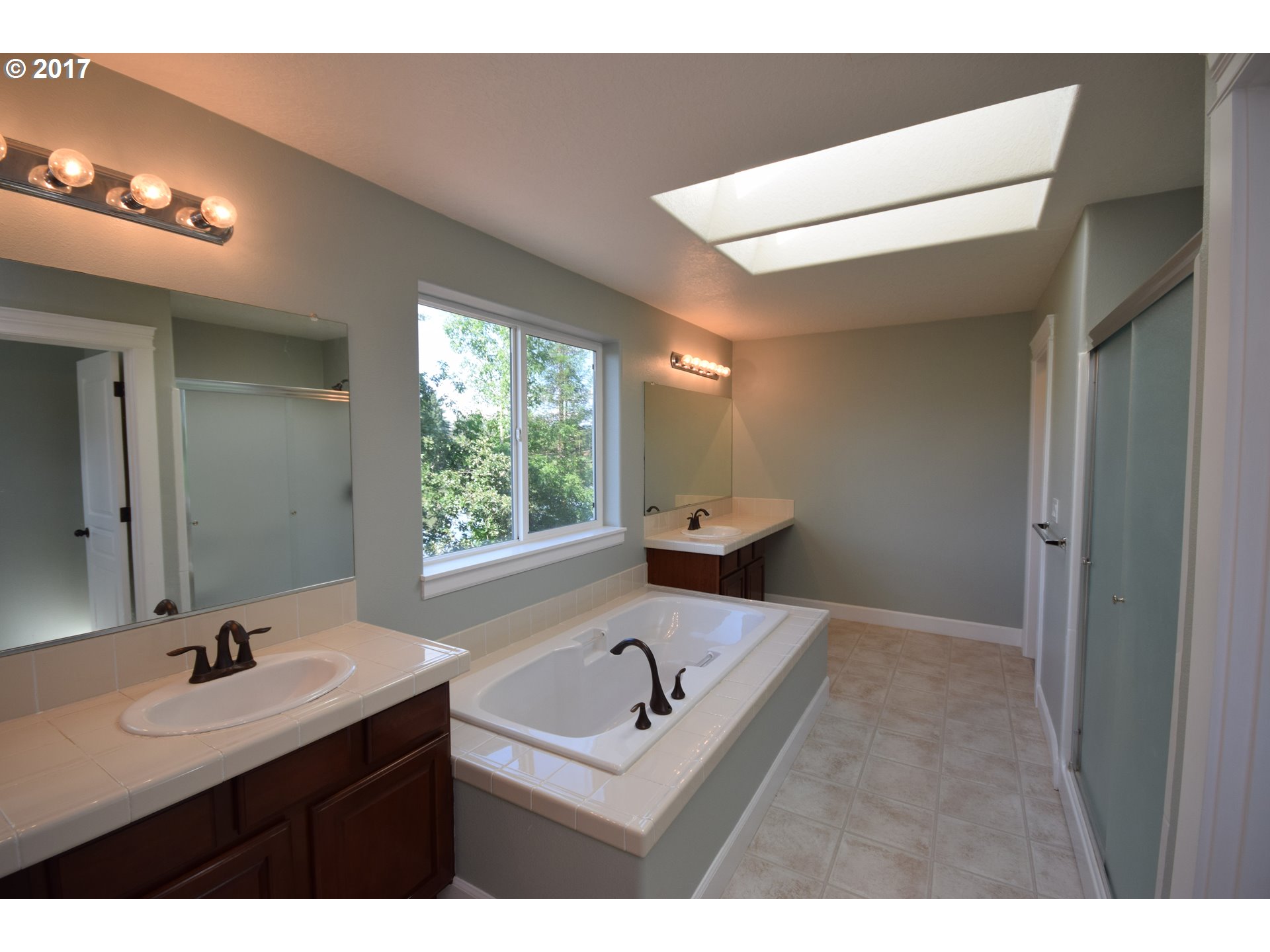 5229 Northwest Shoreline Way Portland, OR 97229 - Photo 24 of 29 a bathroom with a sink a toilet and a mirror