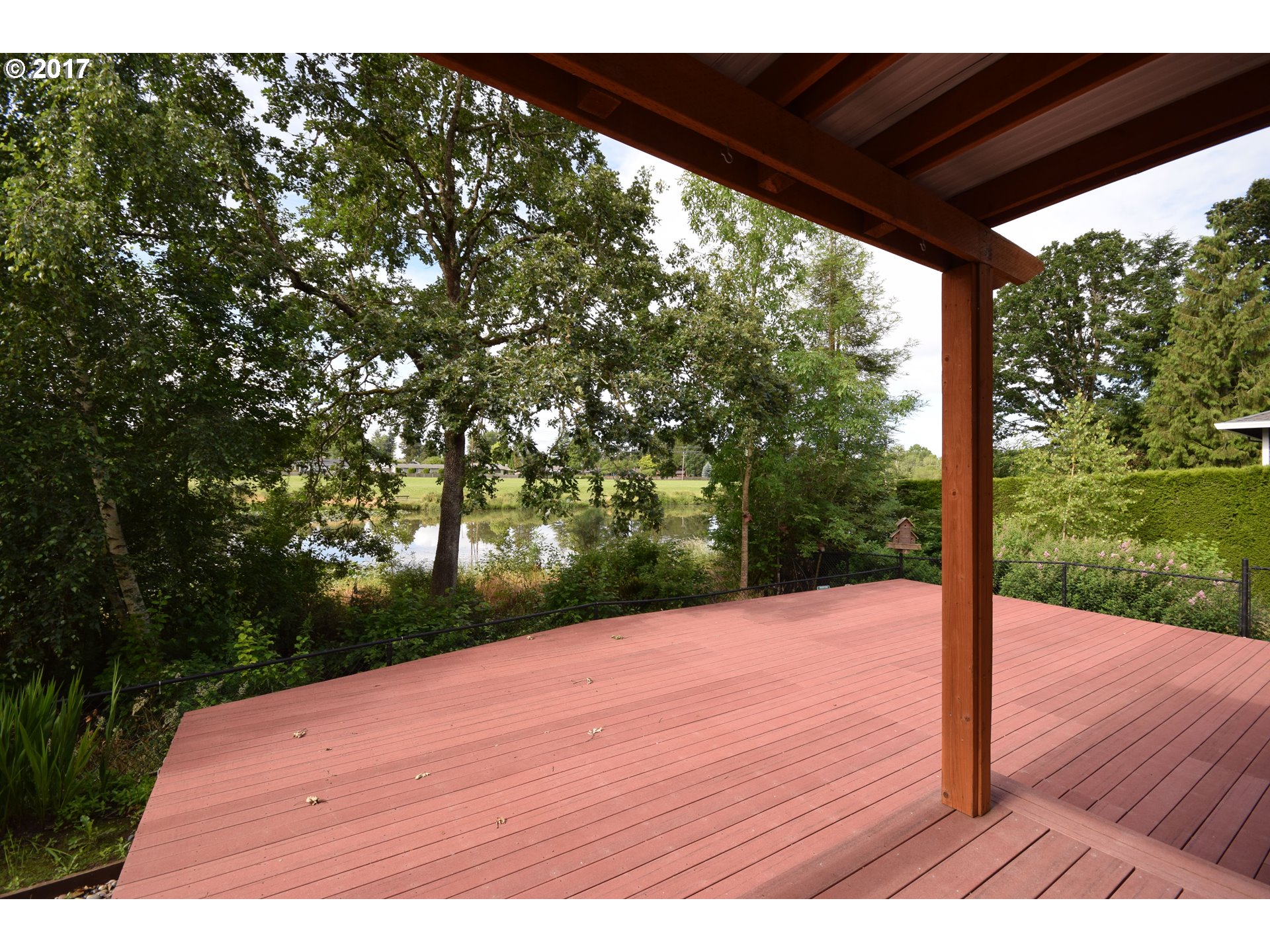 5229 Northwest Shoreline Way Portland, OR 97229 - Photo 26 of 29 a wooden deck with trees in front of it