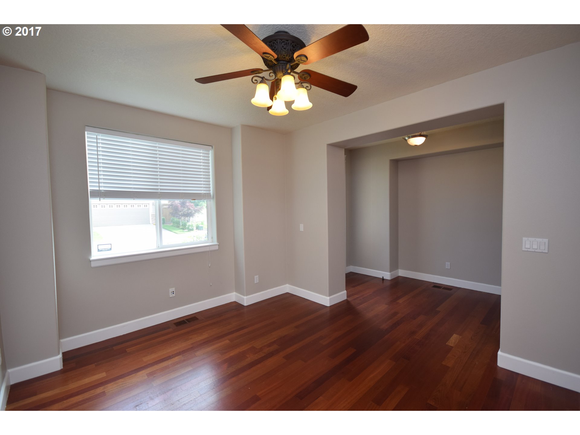 5229 Northwest Shoreline Way Portland, OR 97229 - Photo 4 of 29 a view of an empty room with wooden floor and a window