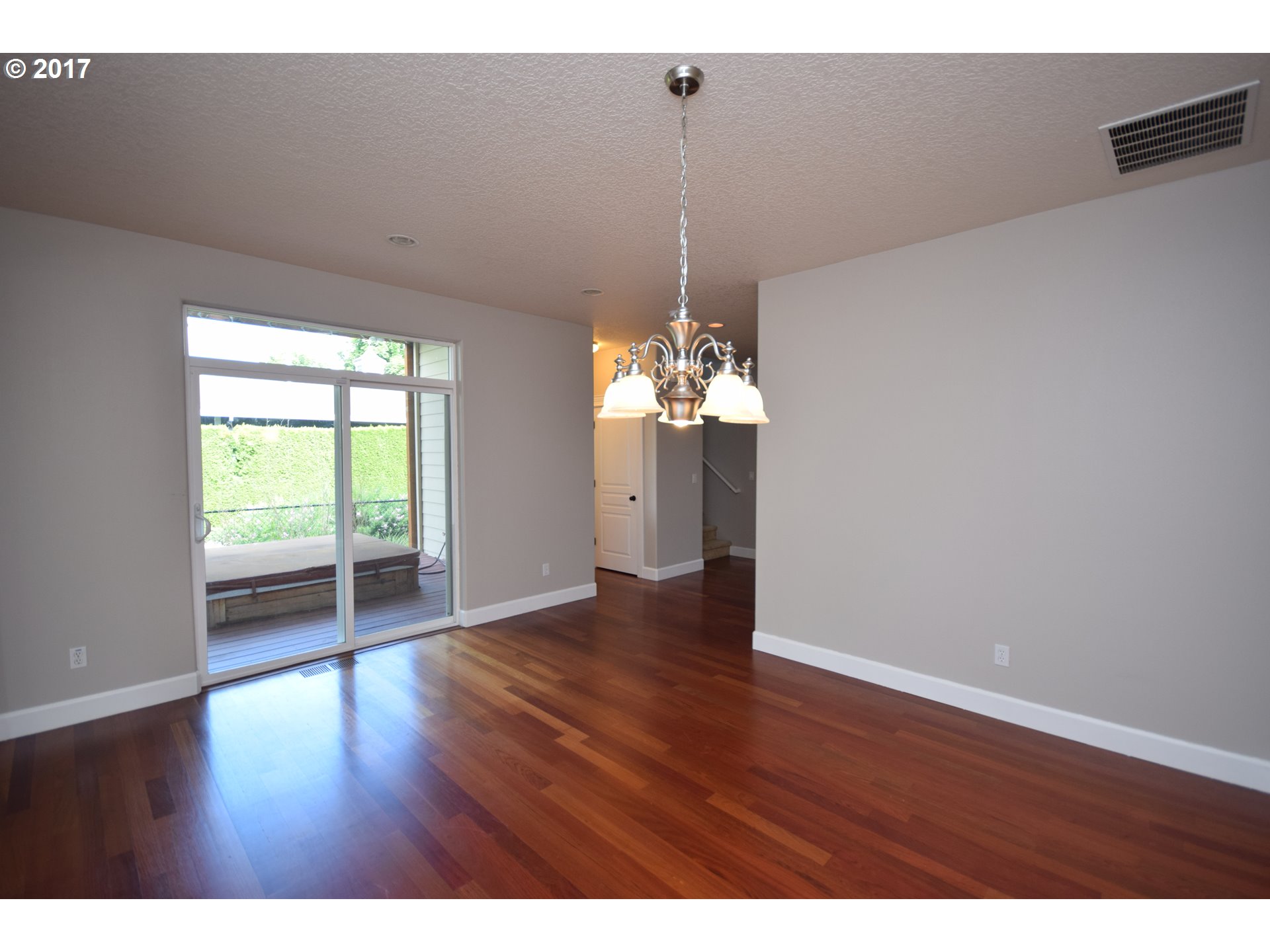5229 Northwest Shoreline Way Portland, OR 97229 - Photo 7 of 29 a view of a room with wooden floor chandelier and a window