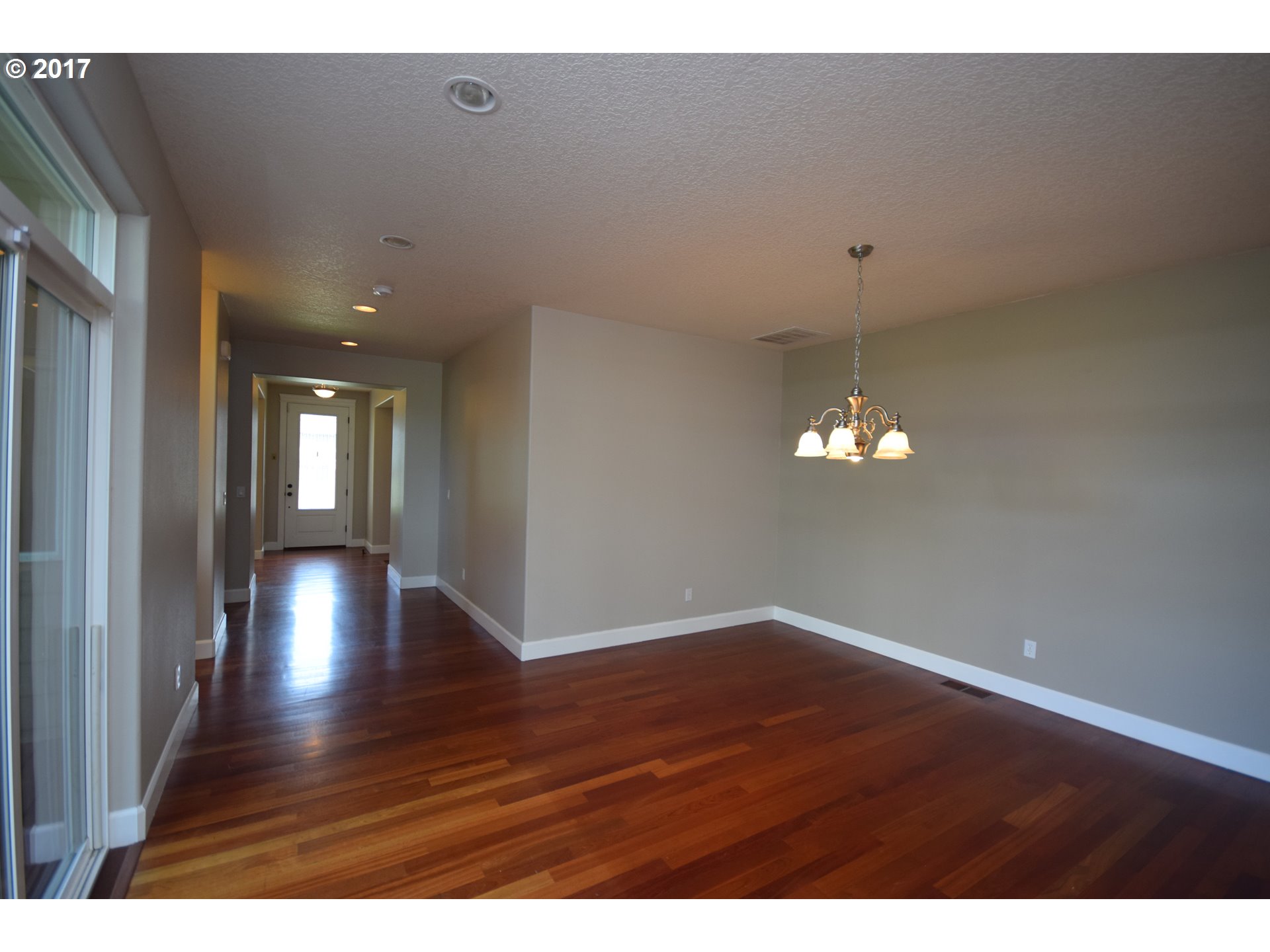 5229 Northwest Shoreline Way Portland, OR 97229 - Photo 8 of 29 a view of an empty room with wooden floor and a window