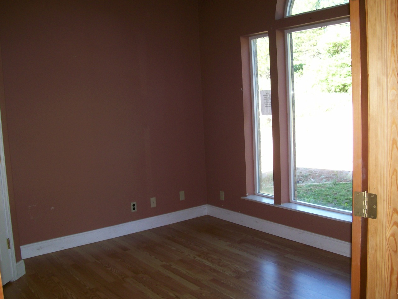 32990 Torrey Pines Road Shingletown, CA 96088 - Photo 3 of 9 a view of an empty room with wooden floor and a window