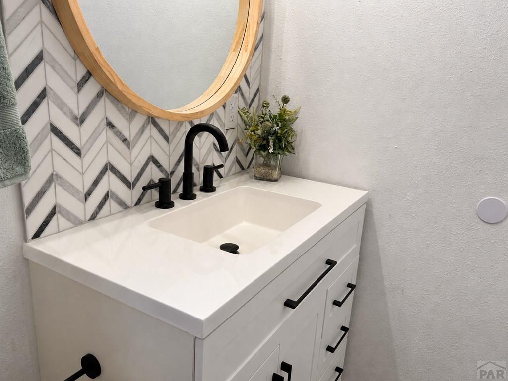 6652 County Rd HH.5 Lamar, CO 81052 - Photo 15 of 22 a bathroom with a sink and a mirror