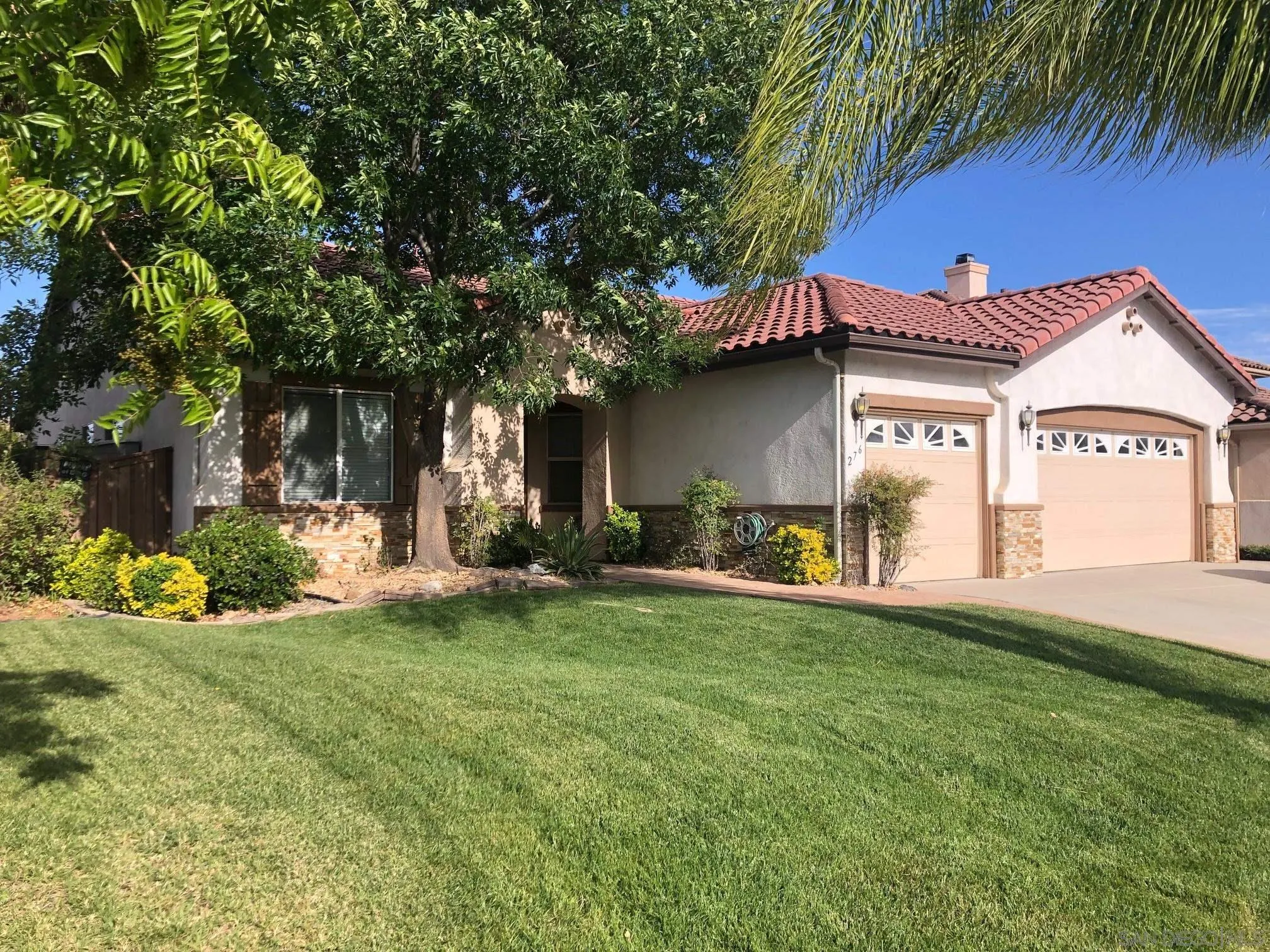 a view of a house with a yard and sitting area