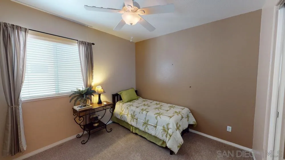 276 South Ralph Road Lake Elsinore, CA 92530 - Photo 12 of 15 a bedroom with a bed and a window