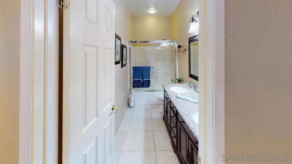 276 South Ralph Road Lake Elsinore, CA 92530 - Photo 13 of 15 a bathroom with a sink and mirror