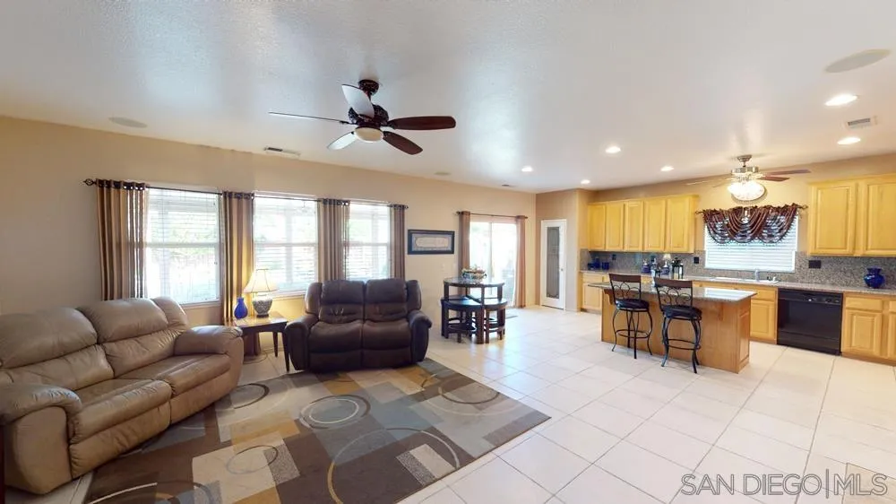 276 South Ralph Road Lake Elsinore, CA 92530 - Photo 2 of 15 a living room with furniture a large window and a dining table