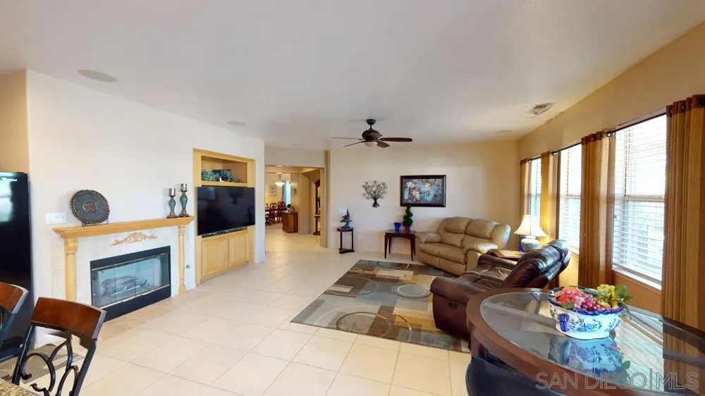 276 South Ralph Road Lake Elsinore, CA 92530 - Photo 5 of 15 a living room with furniture large window and a fireplace