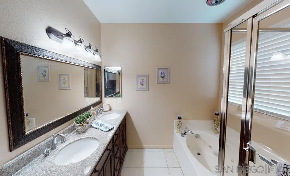 276 South Ralph Road Lake Elsinore, CA 92530 - Photo 8 of 15 a bathroom with a tub sink and mirror