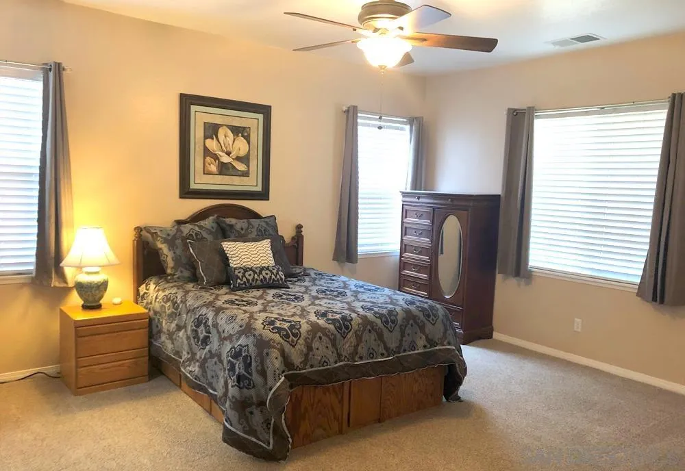 276 South Ralph Road Lake Elsinore, CA 92530 - Photo 10 of 15 a bedroom with a bed and a chandelier