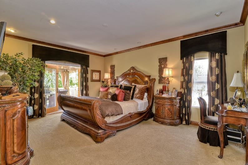 1206 Plum Tree Road Carlsbad, CA 92011 - Photo 20 of 25 MASTER BEDROOM RETREAT WITH FRENCH DOORS TO SPACIOUS PATIO VIEWING POOL, OCEAN, AND LEGOLAND FIREWORKS DURING SOMETIMES OF THE YEAR