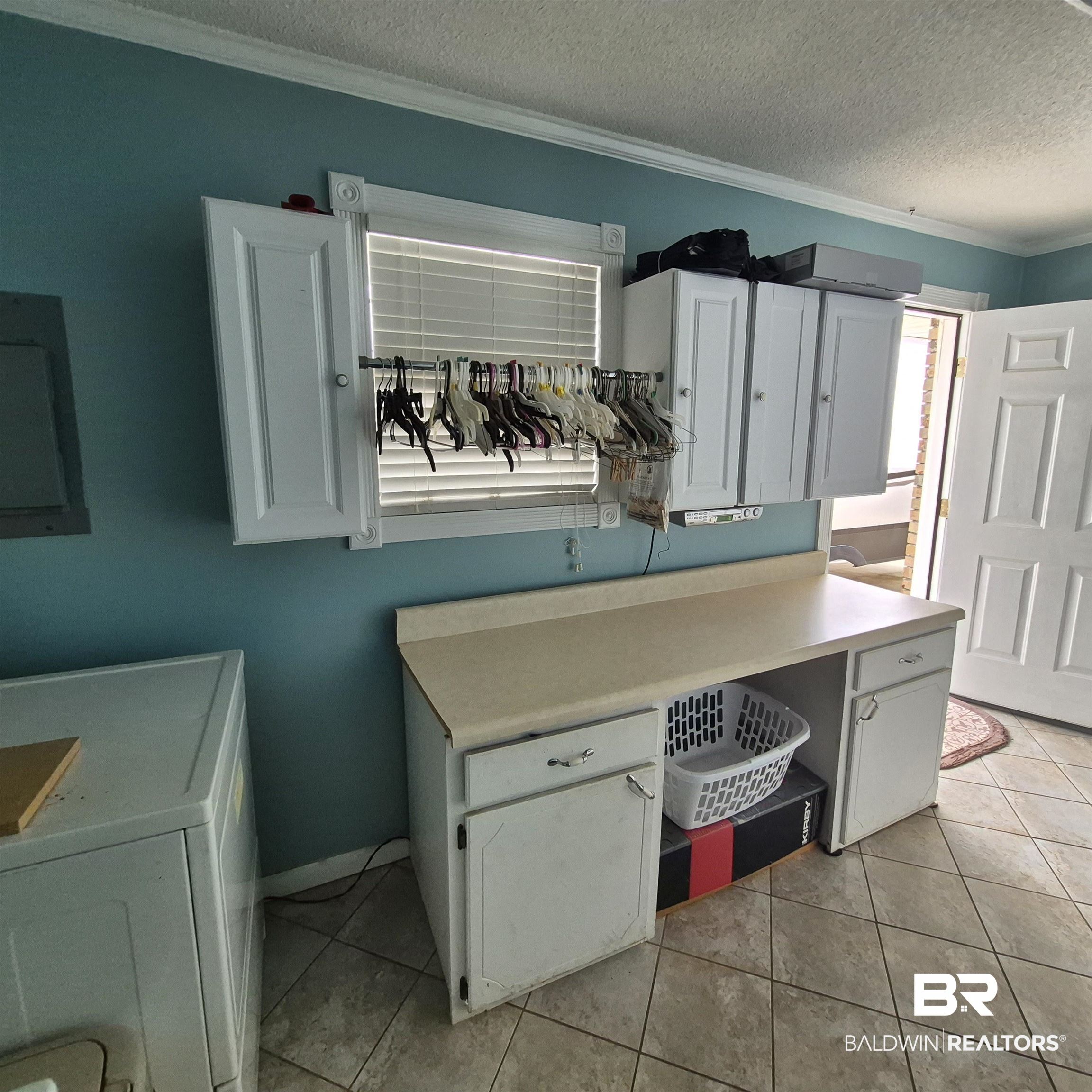 26635 Highway 41 Range, AL 36473 - Photo 36 of 74 Laundry area featuring washer / dryer, electric panel, crown molding, a textured ceiling, and light tile patterned floors
