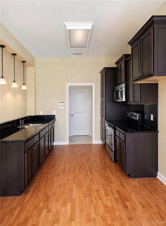 3207 Omega Street Edinburg, TX 78539 - Photo 4 of 13 a kitchen with stainless steel appliances granite countertop a stove a sink and a refrigerator
