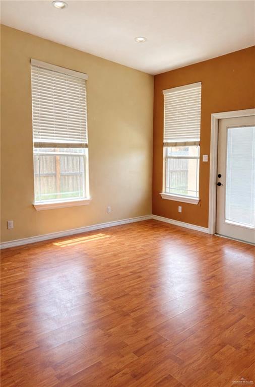 3207 Omega Street Edinburg, TX 78539 - Photo 5 of 13 an empty room with wooden floor and windows