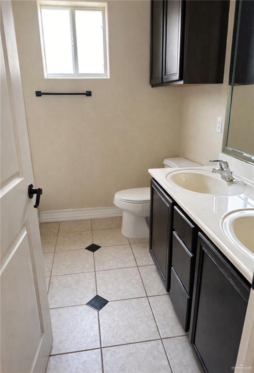 3207 Omega Street Edinburg, TX 78539 - Photo 7 of 13 a bathroom with a sink a toilet and a mirror