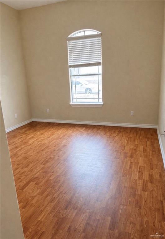 3207 Omega Street Edinburg, TX 78539 - Photo 9 of 13 an empty room with wooden floor and windows