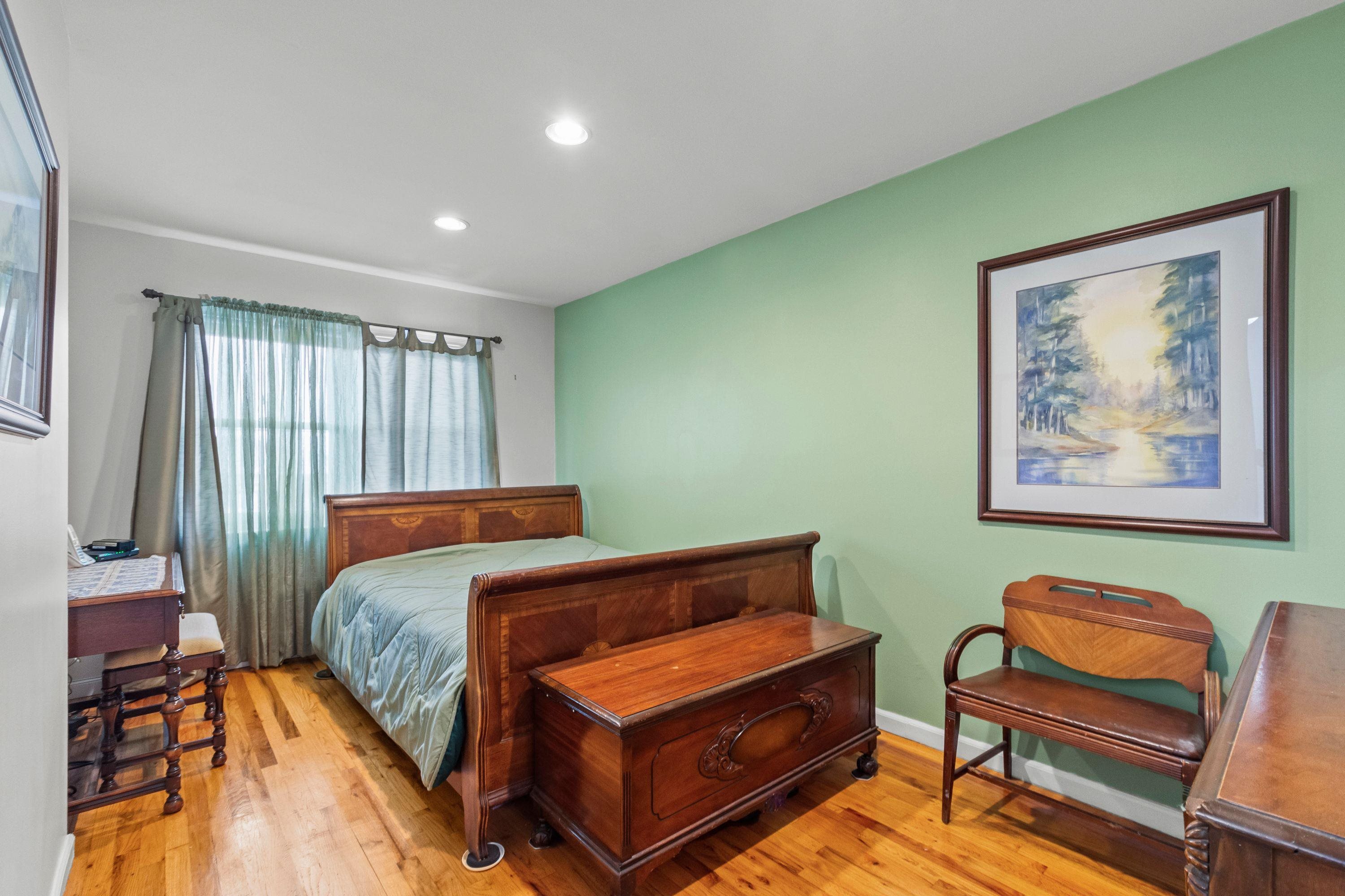 108 Country Village Road Jersey City, NJ 07305 - Photo 9 of 12 a bedroom with a bed and a furniture