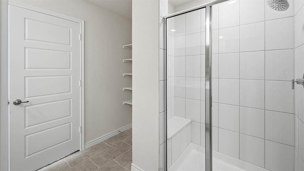 403 Flintlock Road Caddo Mills, TX 75135 - Photo 4 of 26 Bathroom with a shower stall and light tile patterned floors
