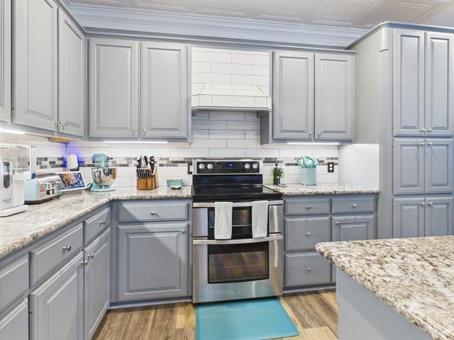 1101 Bunny Rabbit Road Athens, TX 75751 - Photo 13 of 40 a kitchen with stainless steel appliances granite countertop a stove a sink and white cabinets
